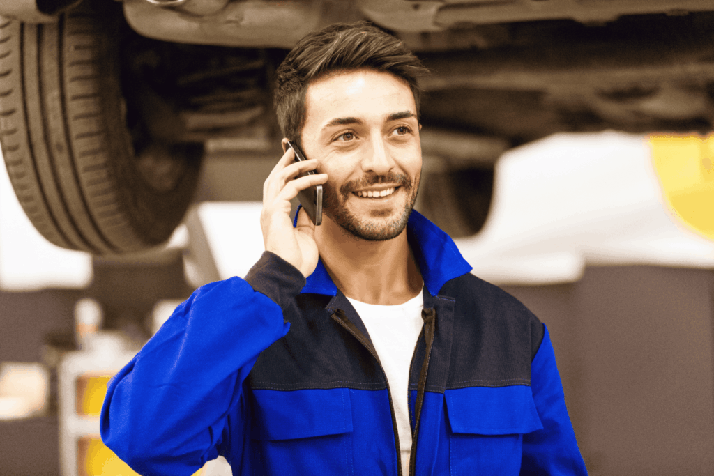 mechanic talking on the phone smiling, tradie website design